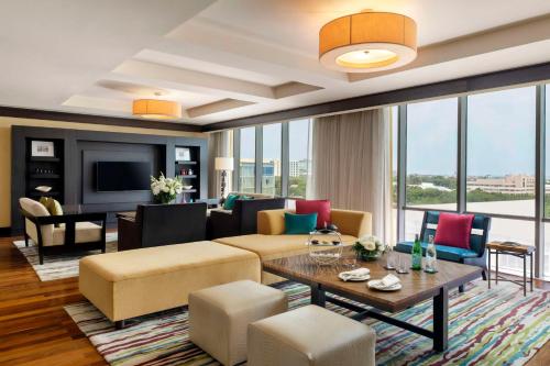 a living room with a couch and a table at Kempinski Hotel Gold Coast City in Accra