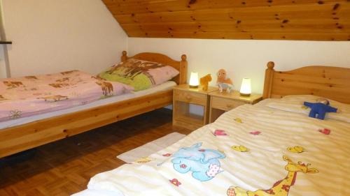 a bedroom with two beds with stuffed animals on them at Hugenhof Kirchzarten bei Freiburg in Kirchzarten