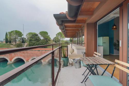 a balcony with a table and a bench on a house at CABANON urban apartments in Peschiera del Garda