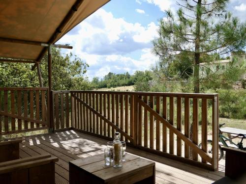 a wooden deck with a table on top of it at La Grisonne - Chalet 3 in Revest-du-Bion