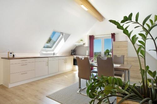 a kitchen and dining room with a table and chairs at Ferienhof Lang in Kressbronn am Bodensee