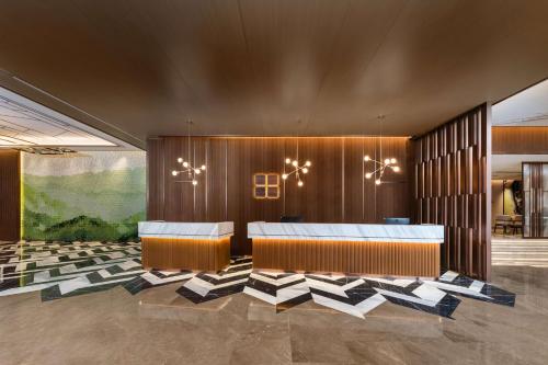 a conference room with a table and chairs at Hilton Garden Inn Huzhou High-Speed Railway Station in Huzhou