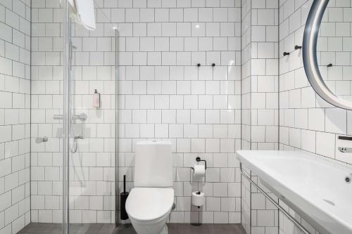 a white bathroom with a toilet and a sink at Aiden by Best Western Karlstad Arena in Karlstad