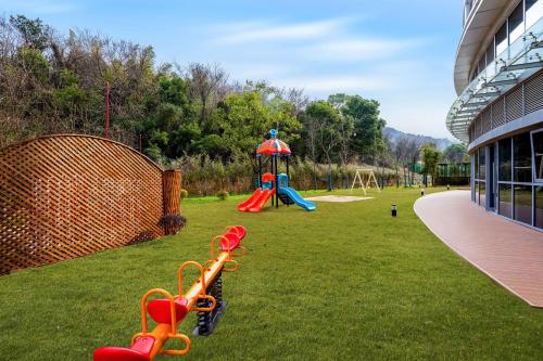 a park with a playground with a slide at Hilton Garden Inn Huzhou High-Speed Railway Station in Huzhou