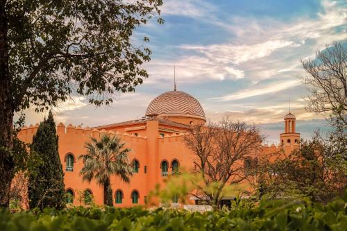 an orange building with a dome on top of it at Alhambra Palace Hotel in Granada