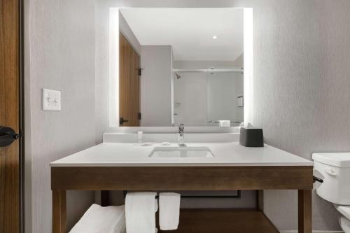 La salle de bains est pourvue d'un lavabo et d'un miroir. dans l'établissement Hyatt Place Flagstaff, à Flagstaff