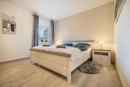 a bedroom with a large bed and a window at Ferienhaus an der Göhrde in Zernien