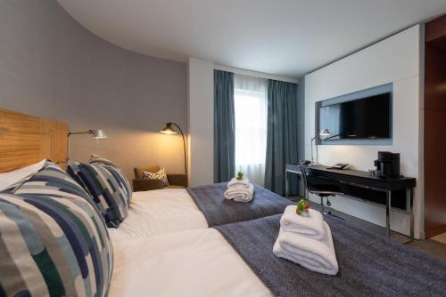 a hotel room with a bed and a desk at Apex City of Edinburgh Hotel in Edinburgh