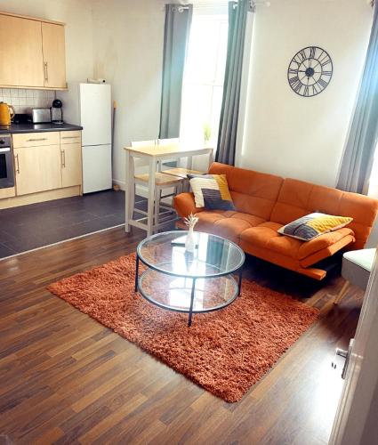 a living room with a couch and a table at Cozy Southampton Retreat: Free Parking for Contractors, Families, and Tourists in Southampton