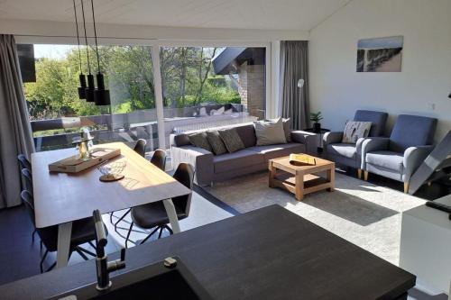 a living room with a couch and a table at Wijk de Brabander 134 in Cadzand