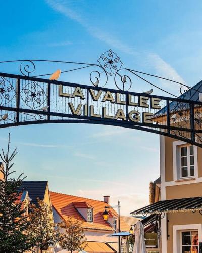 a sign that reads a wine village on a bridge at Disney Luxury Studio in Serris