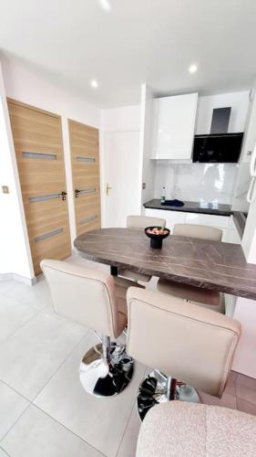 a kitchen with a table and chairs in a room at Disney Luxury Studio in Serris