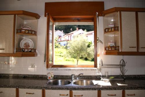 a kitchen counter with a sink and a window at Casa con patio en Nueva de Llanes - El Churru in Nueva de Llanes