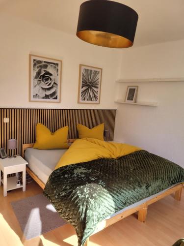 a bedroom with a large bed and a couch at Carl-Schmäcke-Straße 7 in Neuenhagen