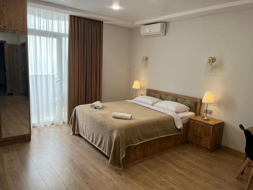 Ένα ή περισσότερα κρεβάτια σε δωμάτιο στο Holiday Premium Apartments Batumi