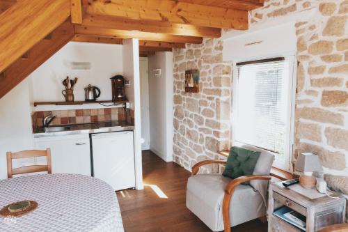 a living room with a stone wall at Penty au Ménec in Carnac