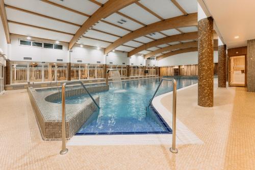 a large indoor swimming pool in a building at Wellness Hotel Step in Prague