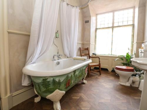 a bathroom with a bath tub and a sink at Dalvorar - Mar Lodge Estate in Ballater