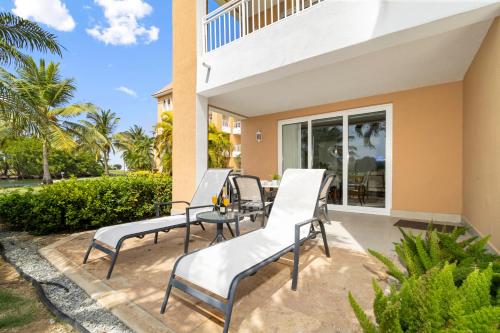 a patio with chairs and a table in front of a house at Divi Village Condo 6 J.E. Irausquin Blvd 93 in Palm-Eagle Beach