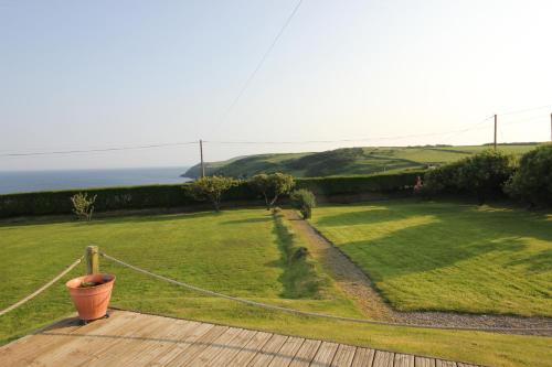 a garden with a view of the ocean at Spacious seaside family house in Aberdaron with large garden and stunning sea views in Aberdaron