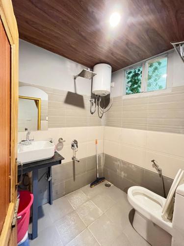 a bathroom with a sink and a toilet at The Dreamcatcher room’s & cafe in Kasol