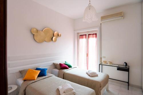 a room with two beds and a window at Happio Apartment in Rome
