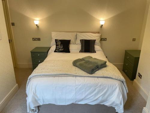 a bedroom with a large white bed with pillows at Ground floor garden apartment in Newark upon Trent