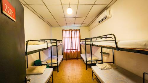 a room with three bunk beds and a window at MAS Athena in Ambepussa