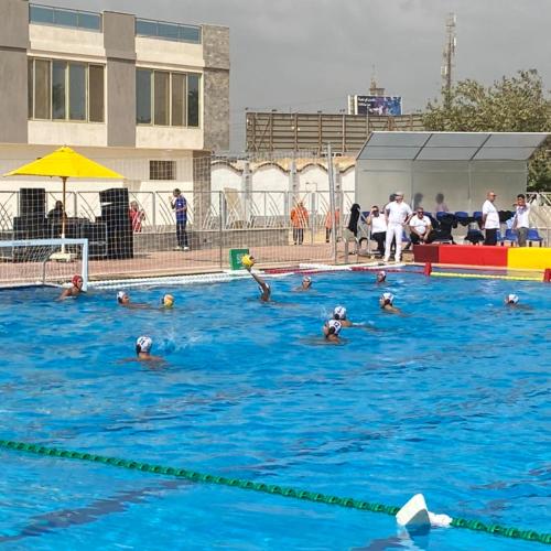 a group of people swimming in a swimming pool at Grand Plaza Hotel & Resort in Qaryat ash Shamālī