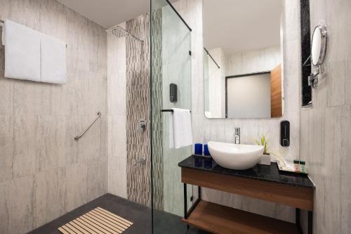 a bathroom with a sink and a glass shower at Fortune Statue of Unity, Ekta Nagar - Member ITC's Hotel Group in Kevadia