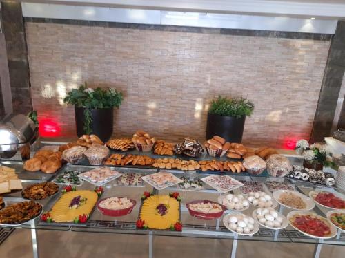 a buffet filled with lots of different types of food at Grand Plaza Hotel & Resort in Qaryat ash Shamālī