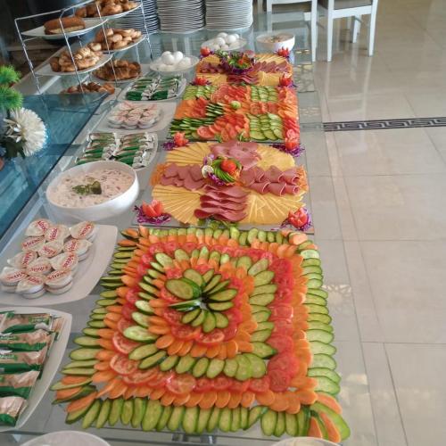 a buffet of different types of food on a table at Grand Plaza Hotel & Resort in Qaryat ash Shamālī