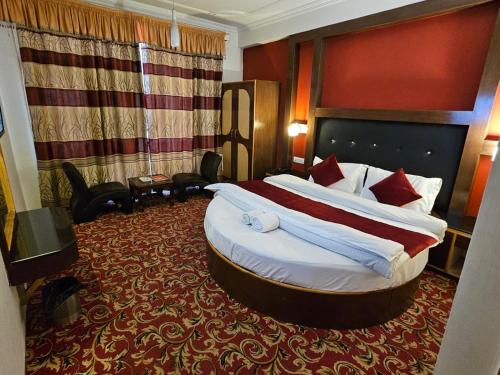 a hotel room with a large bed in a room at Hotel Akash Regency in Manāli