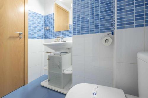 a blue and white bathroom with a toilet and a sink at Apartamento Terraza Bora Bora in El Campello