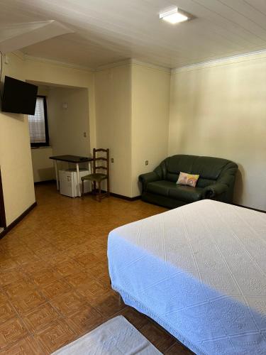 a room with a bed and a couch and a table at Casa Rainha Dª Amélia in Termas de Sao Pedro do Sul