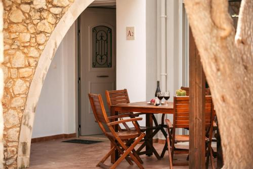 a dining room with a wooden table and chairs at Urania Luxury Suite with pool view -Loutra Resort in Loutra