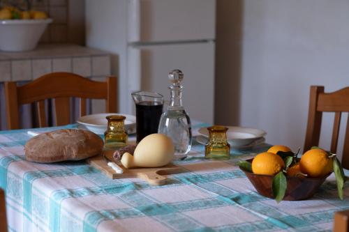 a table with eggs and bread and oranges on it at Borgo Maria Rosa in San Salvatore di Fitalia