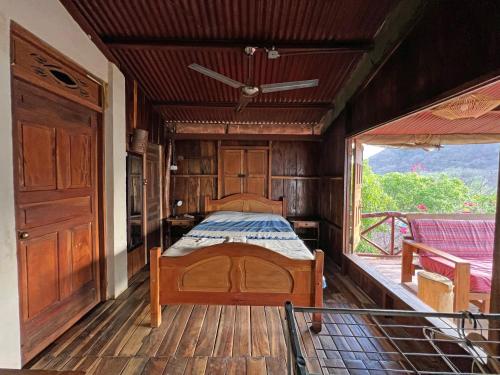 a bedroom with a bed and a large window at 300m to beach/center: 2 bedr-2 bath & great views! in San Juan del Sur