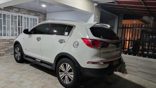 a white car is parked in a garage at Apartamento Fontana in Bucaramanga