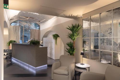 an office with a reception desk and a chair at GombitHotel in Bergamo
