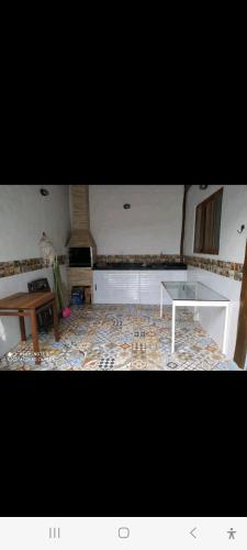 a living room with a table and a coffee table at Casa, em condomínio com piscina, em Maresias in Maresias