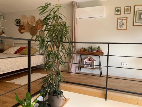 a bedroom with a bed and plants in it at Vilnius Cozy Loft in Vilnius