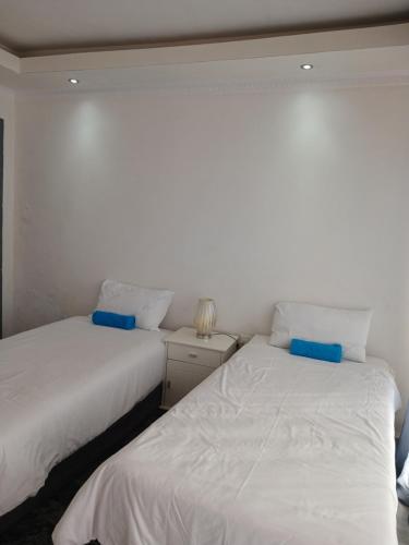 dos camas sentadas una al lado de la otra en un dormitorio en Russell's Rest Rooms en Johannesburgo