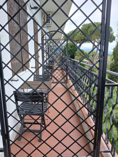 a wrought iron stairway with chairs on a balcony at Hotel Ristorante Radar in Carrara