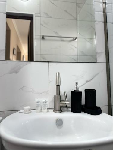 a bathroom with a sink and a mirror at Meshia Apartment in Kazbegi