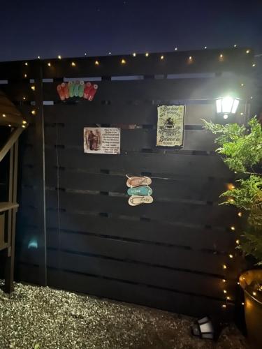 a black wall with signs and lights on it at Donegal Cabin with Hot tub Option in Dernacally