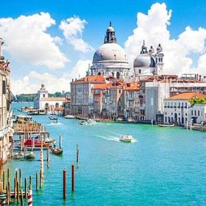 a view of a river with boats and buildings at Appartamenti Residence Foscolo in Lido di Jesolo