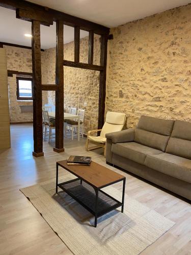 a living room with a couch and a coffee table at La Casona de 1717 in El Burgo de Osma