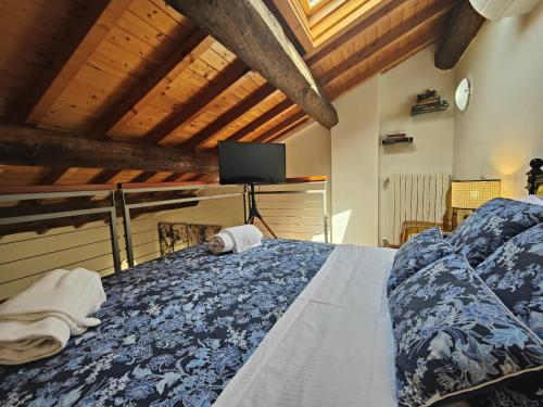 a bedroom with a bed with a tv on it at Giardino Giusti House & Court in Verona