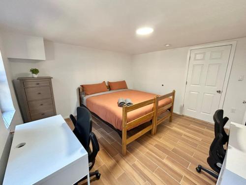 a bedroom with a bed and a desk and chairs at 0230-Central Cozy 2B 1B in Hoboken